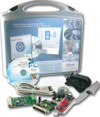 Figure 2. The complete DAvE Drive Application Kit includes a drive card with XC886, a power board, DriveMonitor USB-CAN bridge for realtime monitoring, and a CD-ROM with a free tool chain for software development